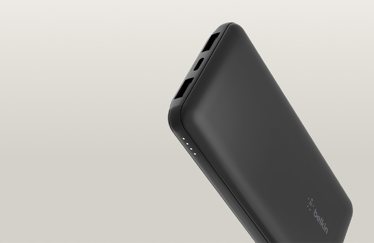 BoostCharge Power Bank 10K with Integrated Cable shown in black and pink, featuring a compact design with a built-in charging cable and LED battery indicators against a neutral background.